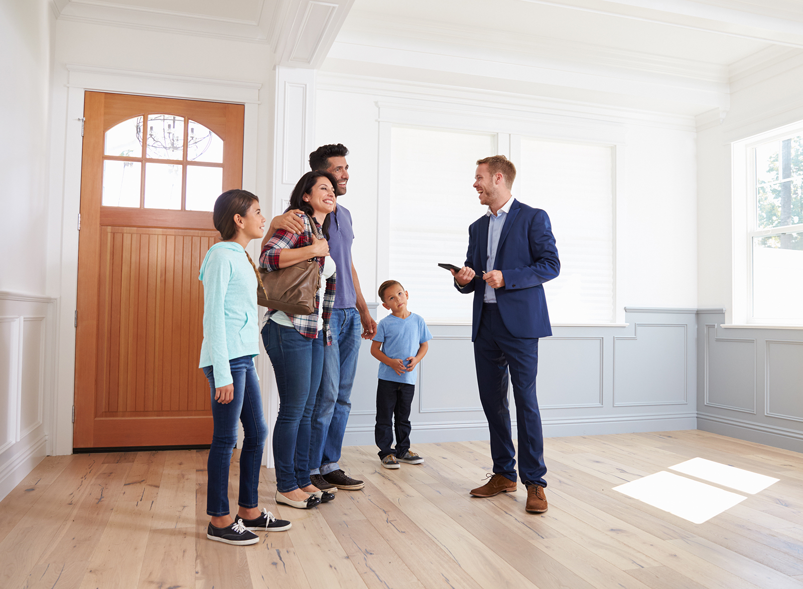 Realtor Showing Hispanic Family Around New Home